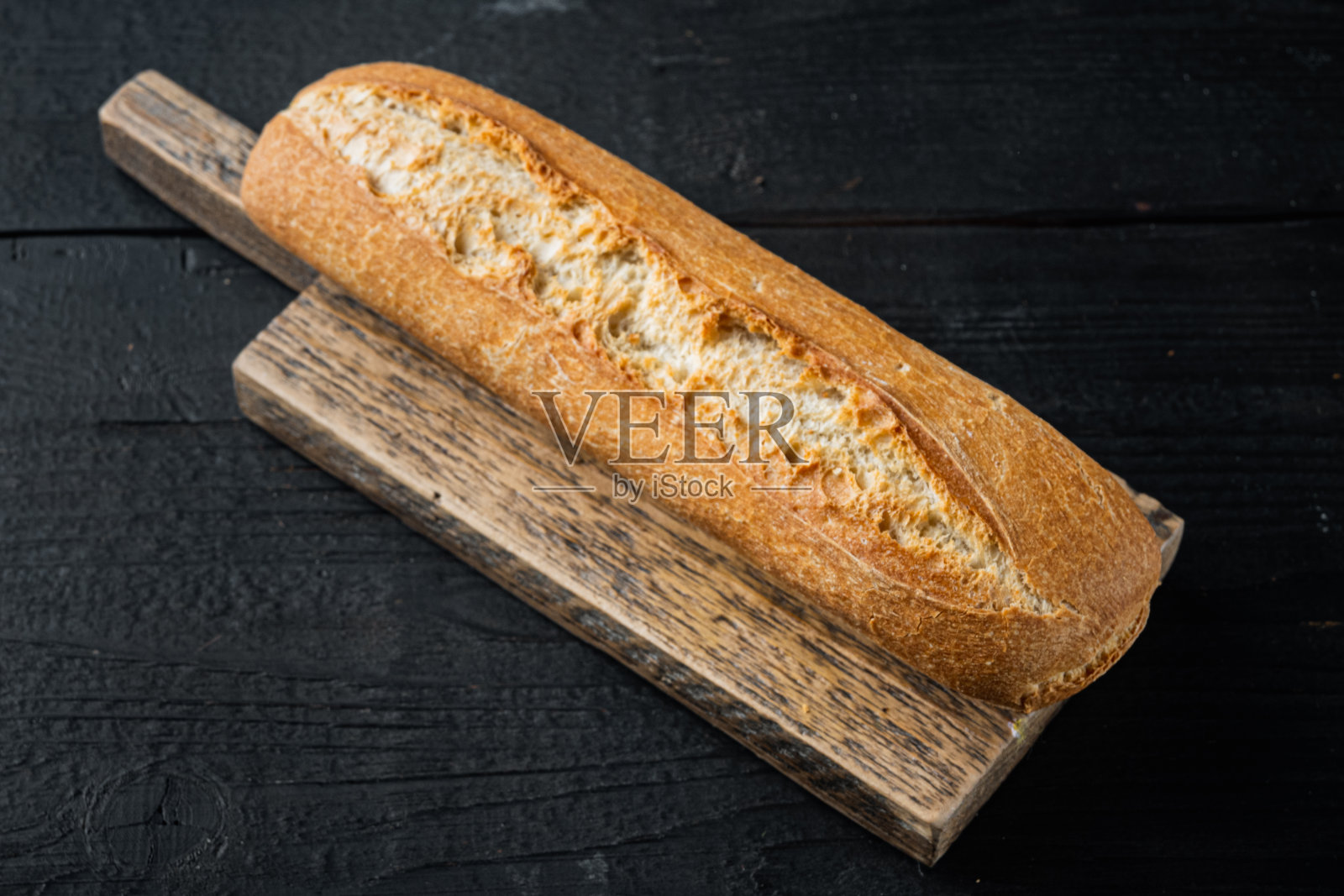 法式长棍面包,在黑色木桌的背景上照片摄影图片