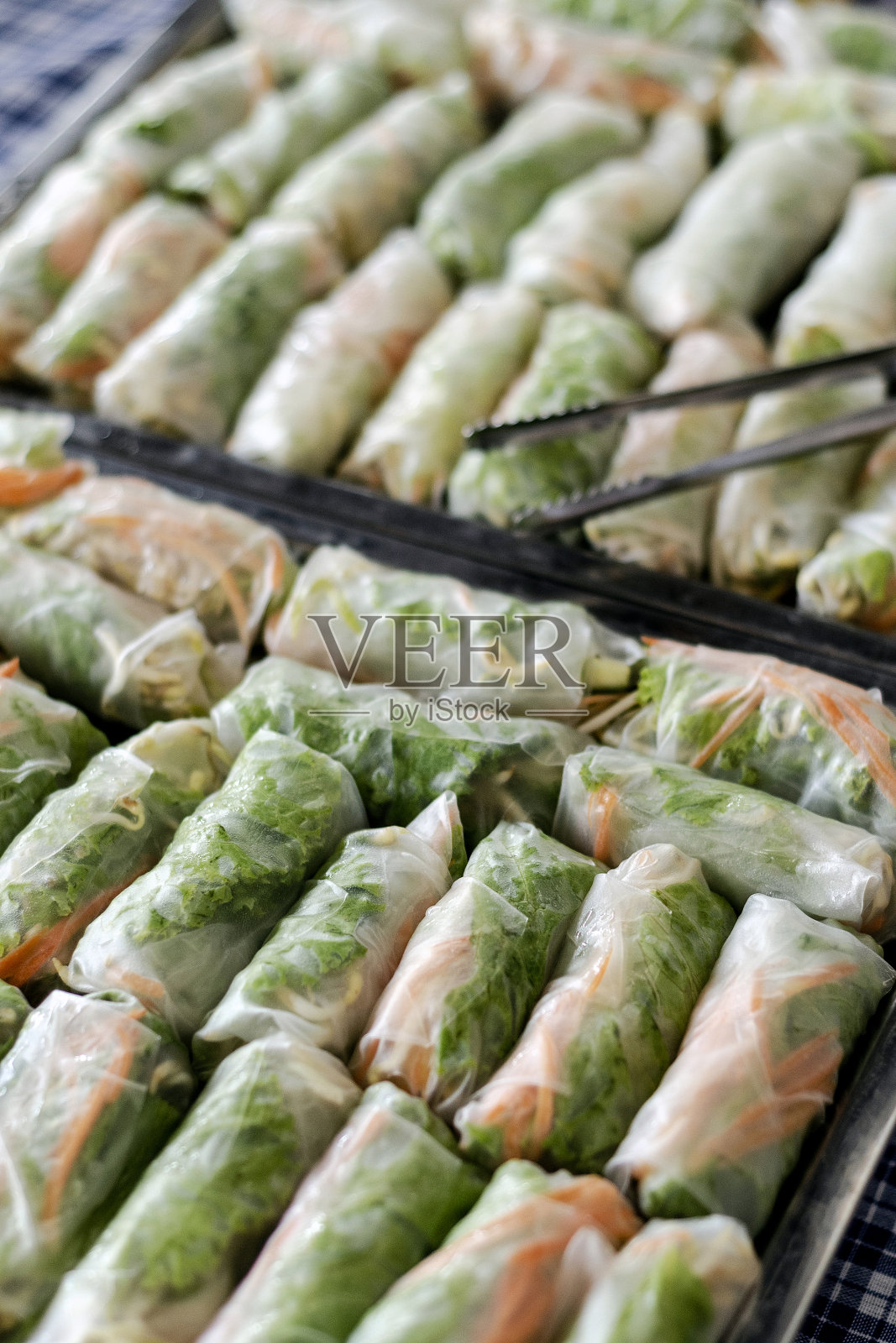 许多新鲜的泰国春卷在托盘上的自助餐桌上的功能照片摄影图片