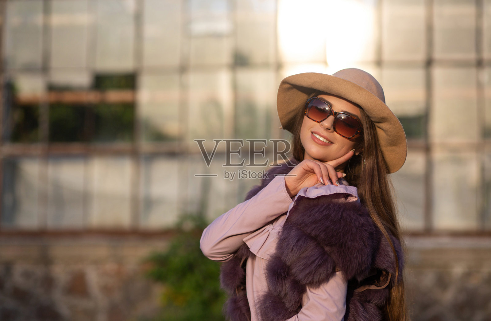 街道肖像可爱的黑发模特戴着帽子和太阳镜,享受温暖的天气。空的空间照片摄影图片