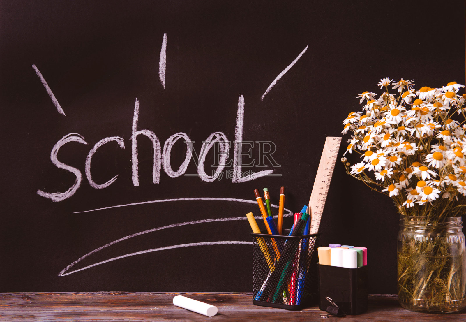 黑板上题字,有钢笔、铅笔、粉笔、洋甘菊花照片摄影图片