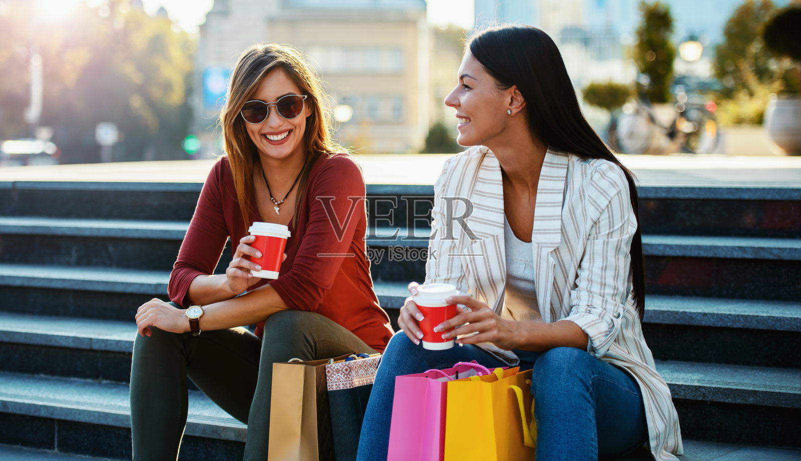 购物时间。美女们在城里购物后休息一下。消费主义、购物、生活理念照片摄影图片