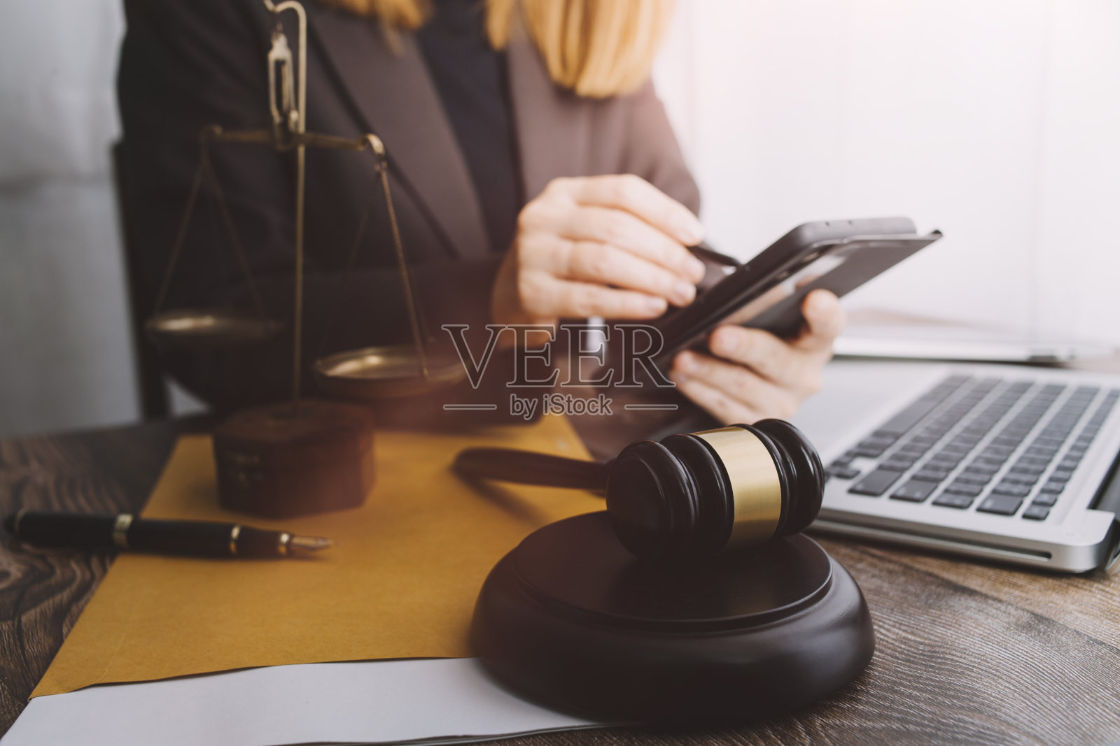 正义与法律观念。男法官在法庭上用木槌工作,电脑和对接键盘,眼镜,在晨光下放在桌子上照片摄影图片