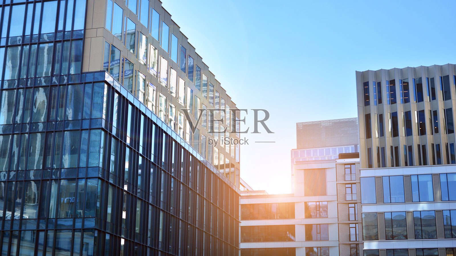 玻璃幕墙的建筑有着蔚蓝的天空。照片摄影图片