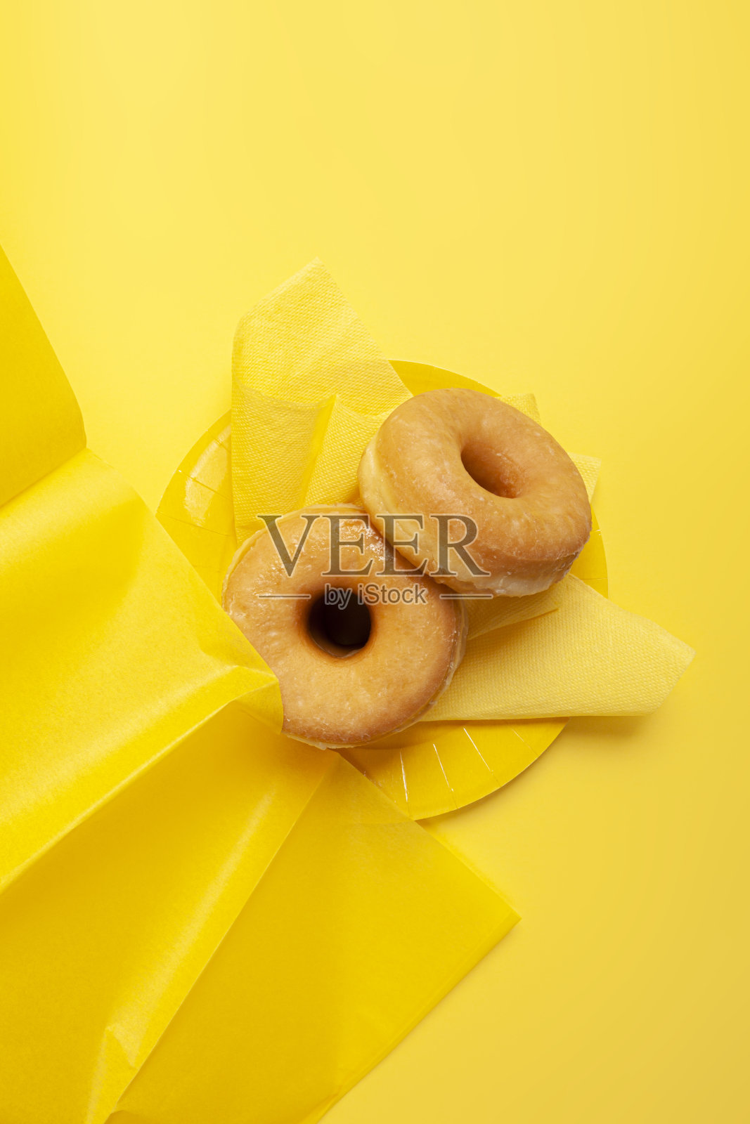 黄色背景上的釉面甜甜圈照片摄影图片