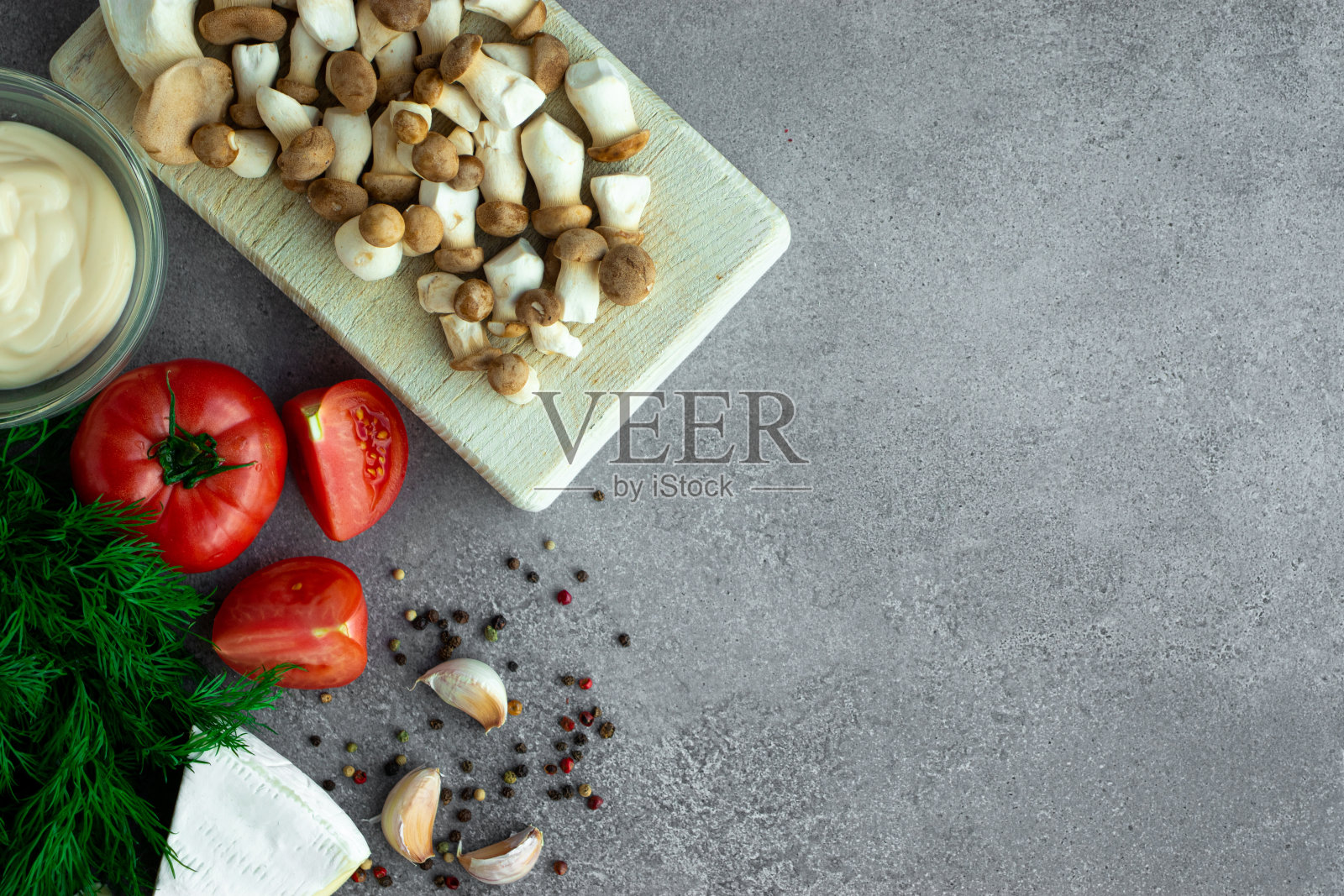 灰色背景上有小蘑菇、西红柿、sus和香料照片摄影图片