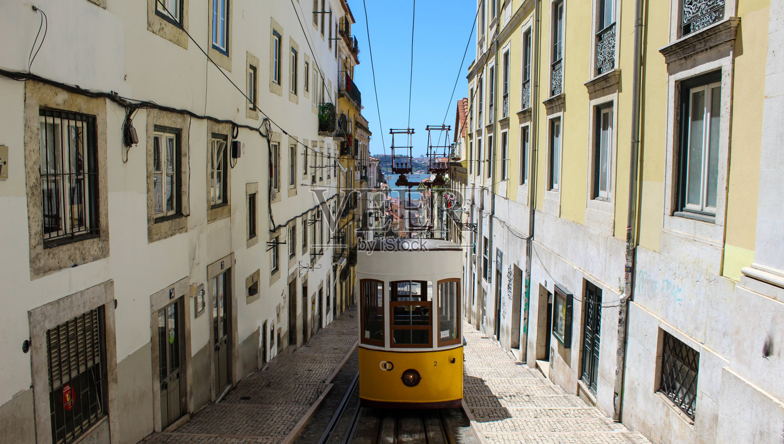 葡萄牙里斯本大街上的老式黄色电车。著名的旅游目的地。里斯本电车在狭窄的街道上。照片摄影图片