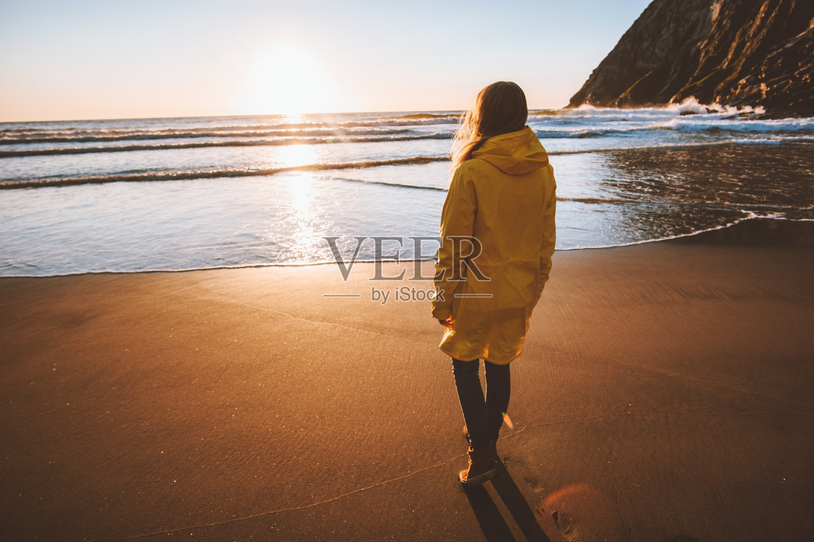 女人独自行走在挪威的沙滩上享受日落海景旅行生活方式度假旅游户外旅行照片摄影图片