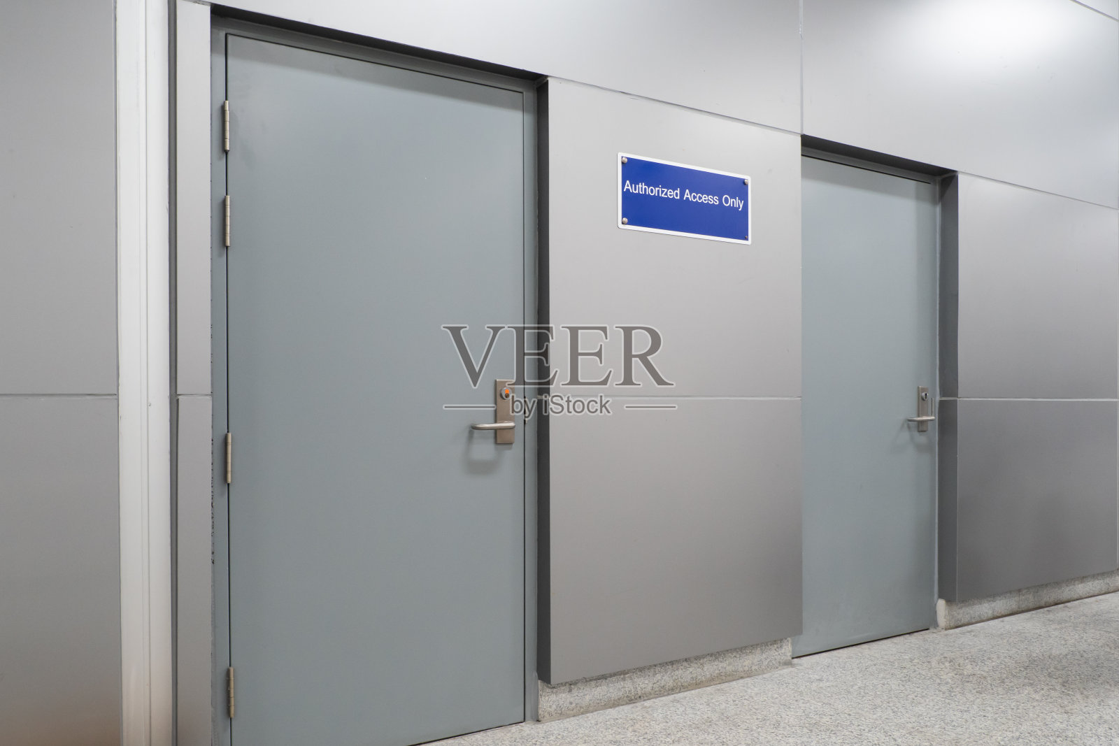 仅限金属门附近墙上的授权员工标志。照片摄影图片