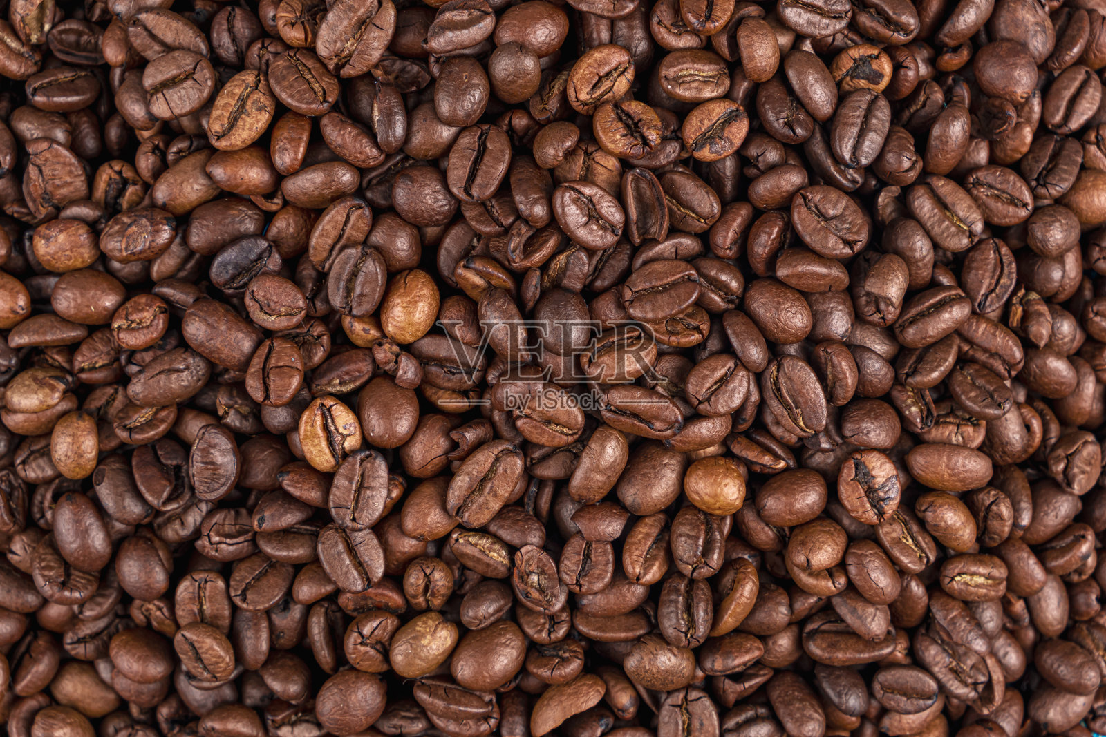 近距离在桌子上烤咖啡豆。纹理。背景照片摄影图片