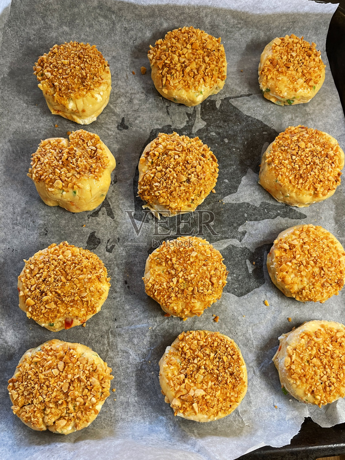 新鲜烘焙,自制的奶酪司康饼在羊皮纸/防油纸内衬不粘烤箱托盘,花生壳和磨碎,帕玛森奶酪,家庭烘焙,高架视野照片摄影图片