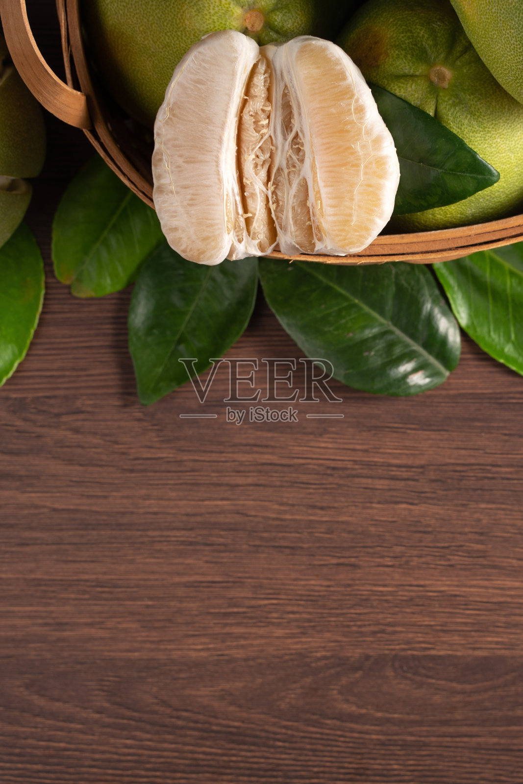 新鲜的柚子水果放在深色木桌背景上。照片摄影图片