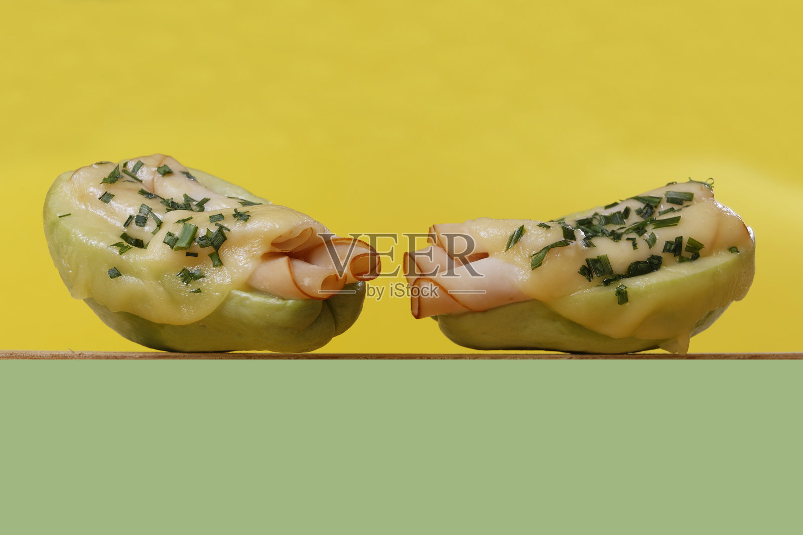 烤山毛榉配火腿,芝士和韭菜,以黄色,绿色和紫色为背景。照片摄影图片