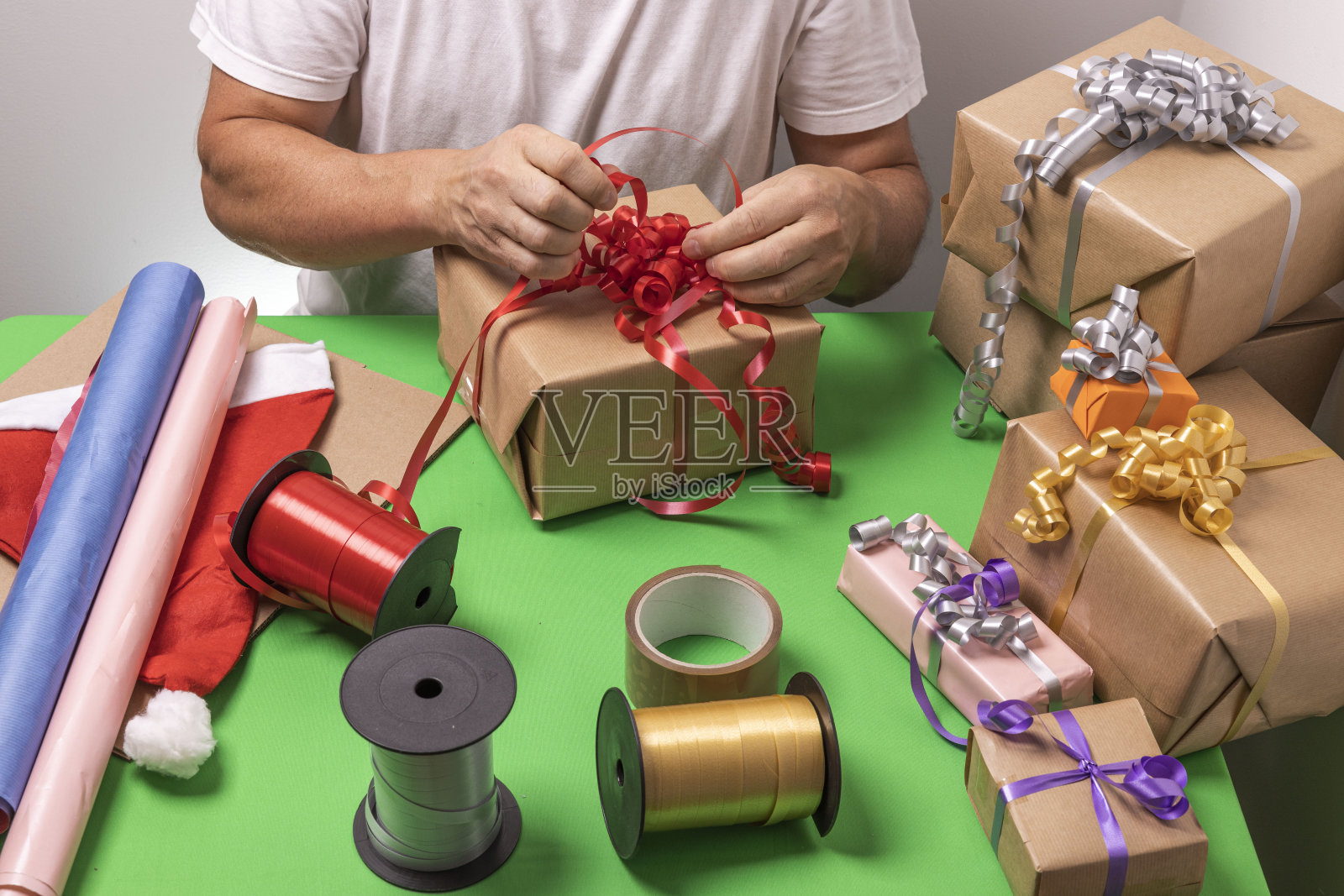 漂亮的男人手包装圣诞礼物。瑞典。照片摄影图片