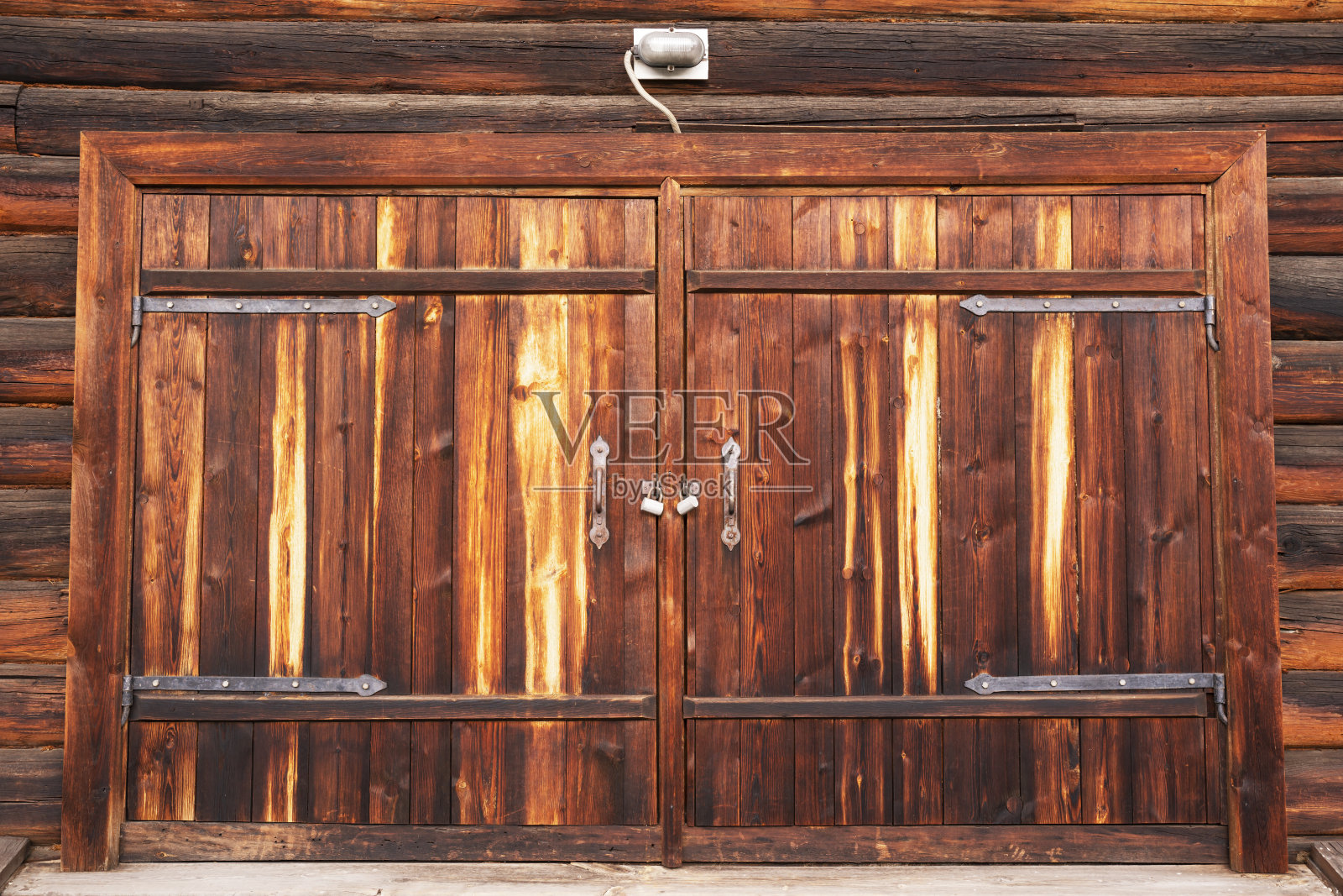 木门或大门用两个金属锁关闭。照片摄影图片