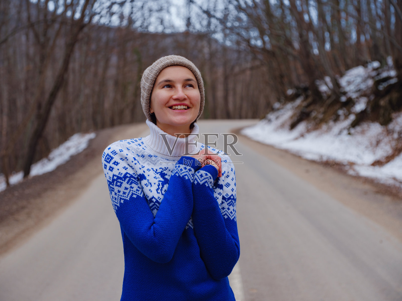 美丽的女人站在冬天的森林里照片摄影图片