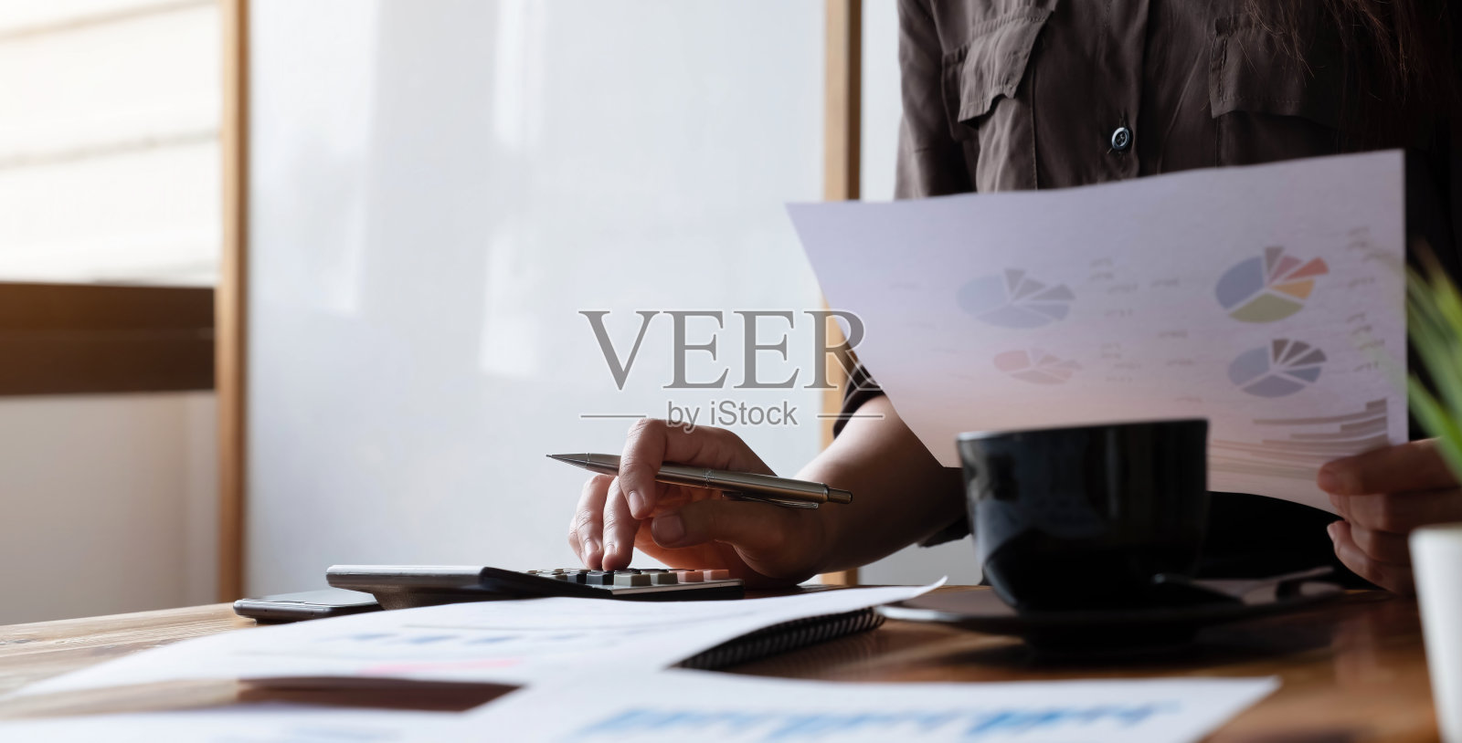 接近商人使用计算器和笔记本电脑计算金融,税务,会计,统计和分析研究的概念照片摄影图片