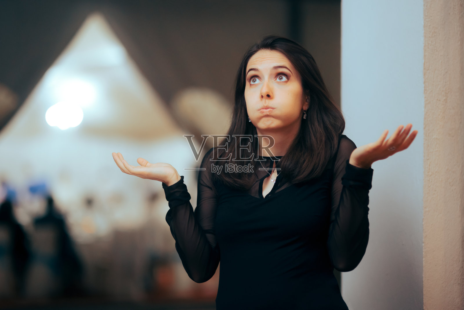 耸耸肩的派对客人思考和决定照片摄影图片