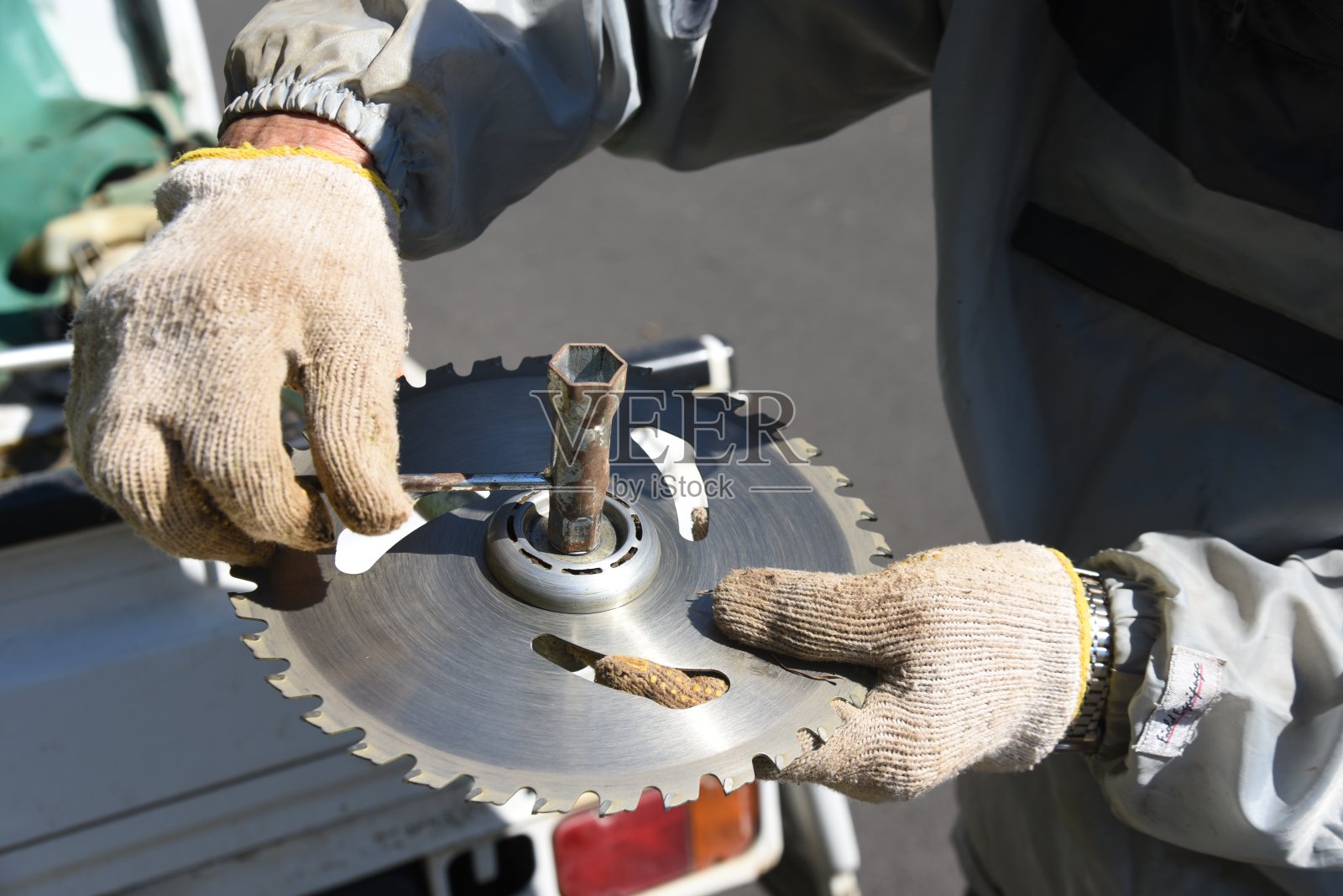 用割草机除草的农民。照片摄影图片