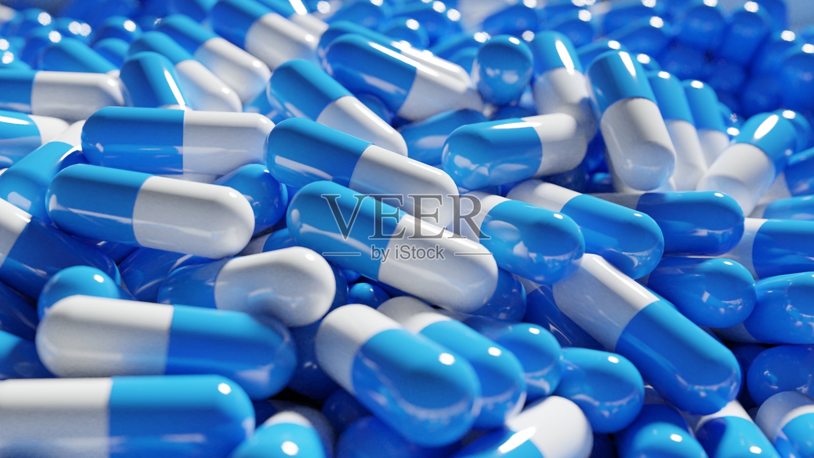 在制造状态下3D渲染了一堆蓝白色胶囊药丸。Covid - 19实验性抗病毒药物。照片摄影图片