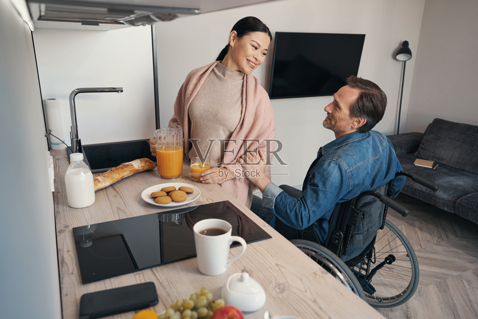 快乐的女性与挚爱的残疾丈夫共进早餐照片摄影图片