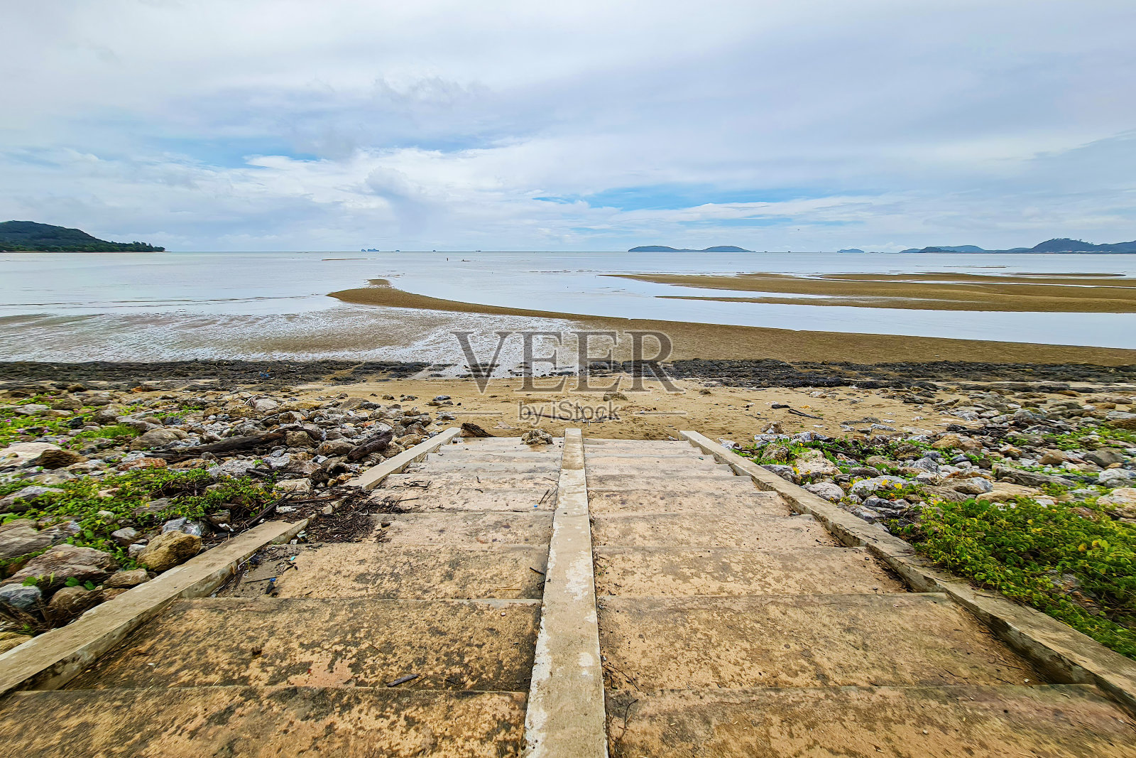 在泰国,清晨的沙滩岩石低潮与台阶云蓝色的天空景观照片摄影图片
