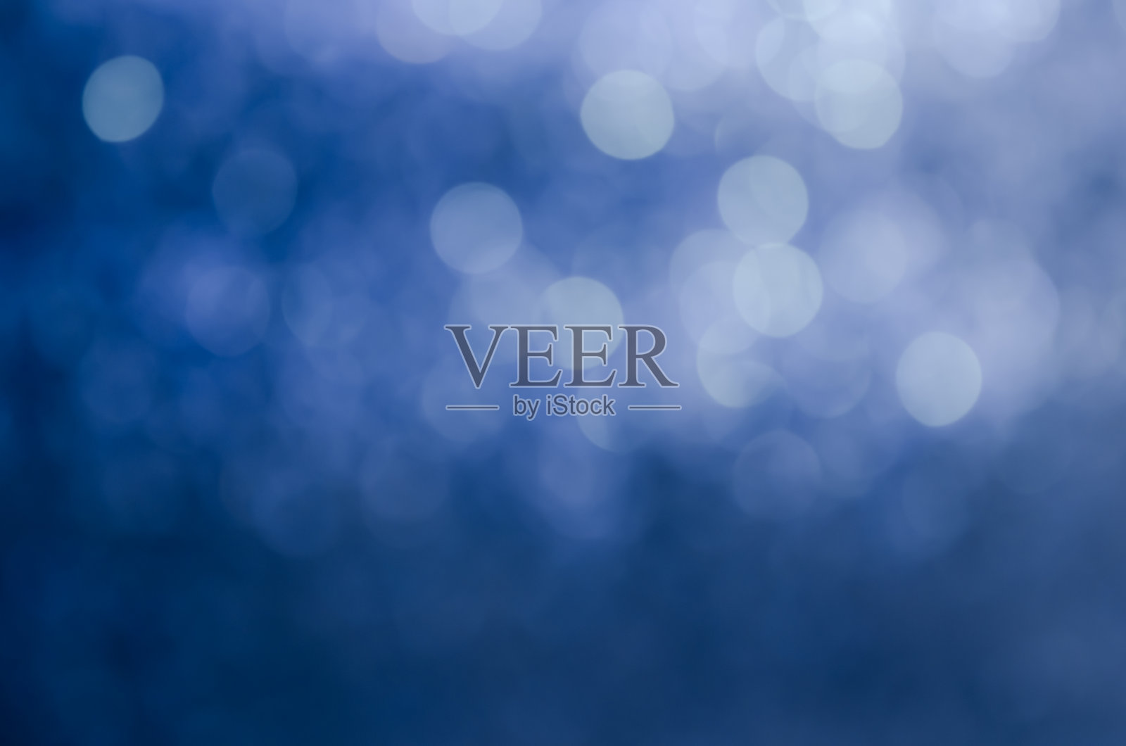 抽象的蓝色散景闪烁背景。照片摄影图片