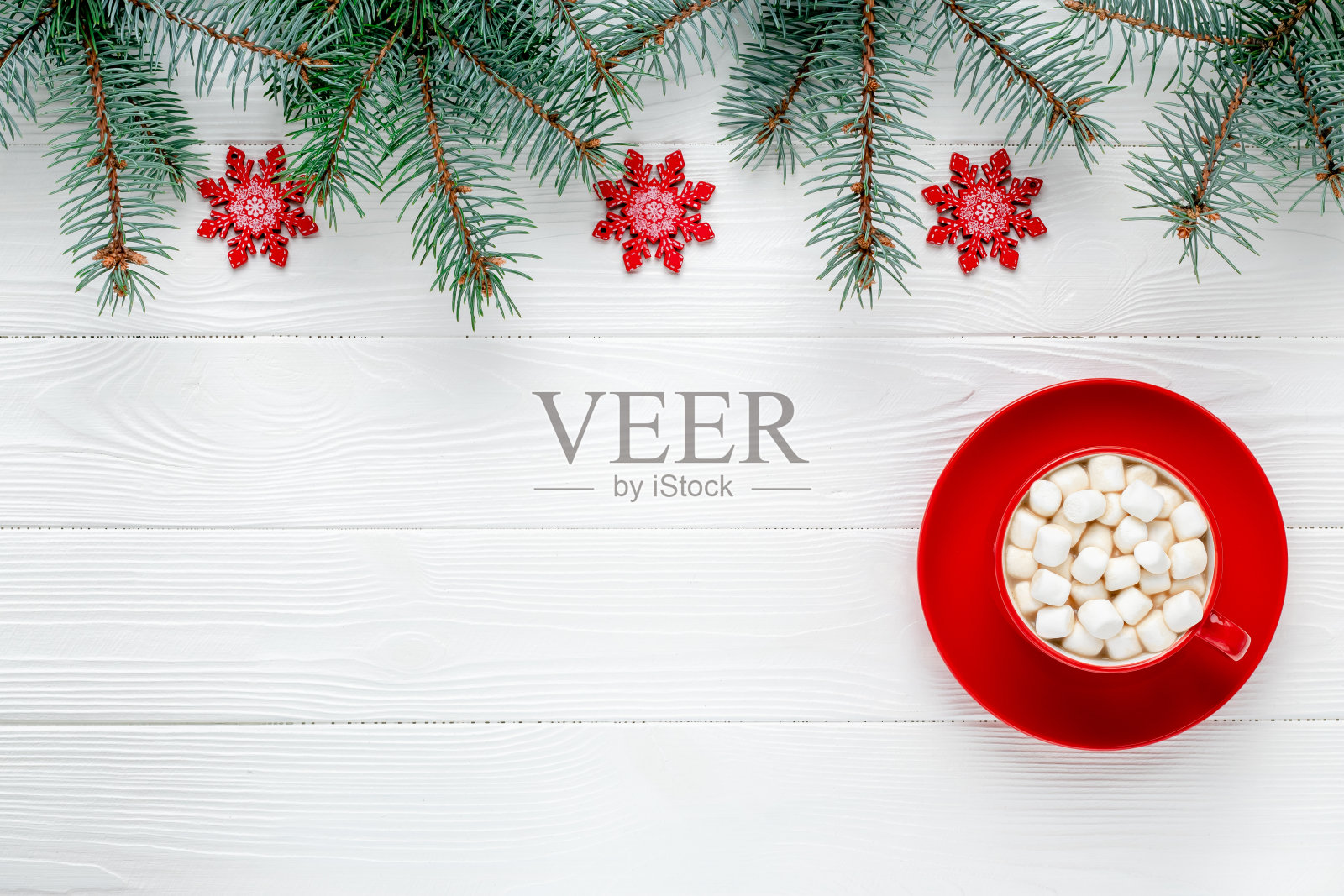 圣诞贺卡上有红咖啡和雪花。新年的框架与节日装饰。云杉分支。模板与复制空间。模式与文本的位置。冬天的模型。照片摄影图片