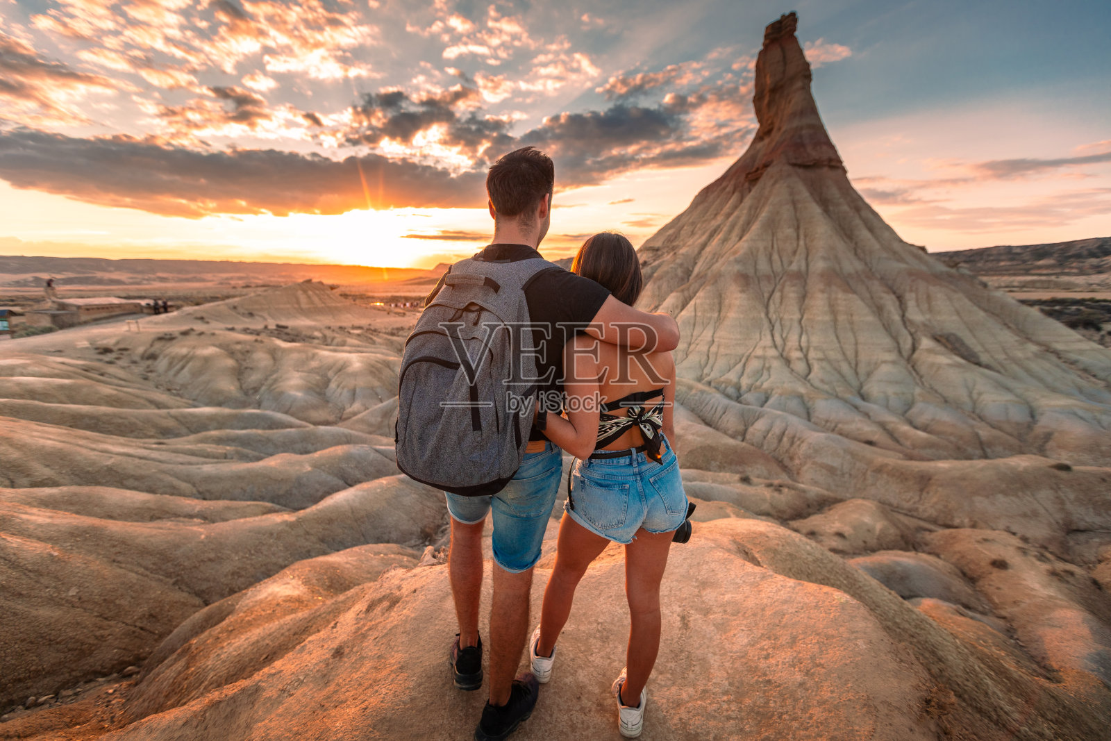 在巴斯克地区的纳瓦拉,一对年轻的白人夫妇拥抱在一起,看着著名的Castildetierra自然纪念碑。照片摄影图片