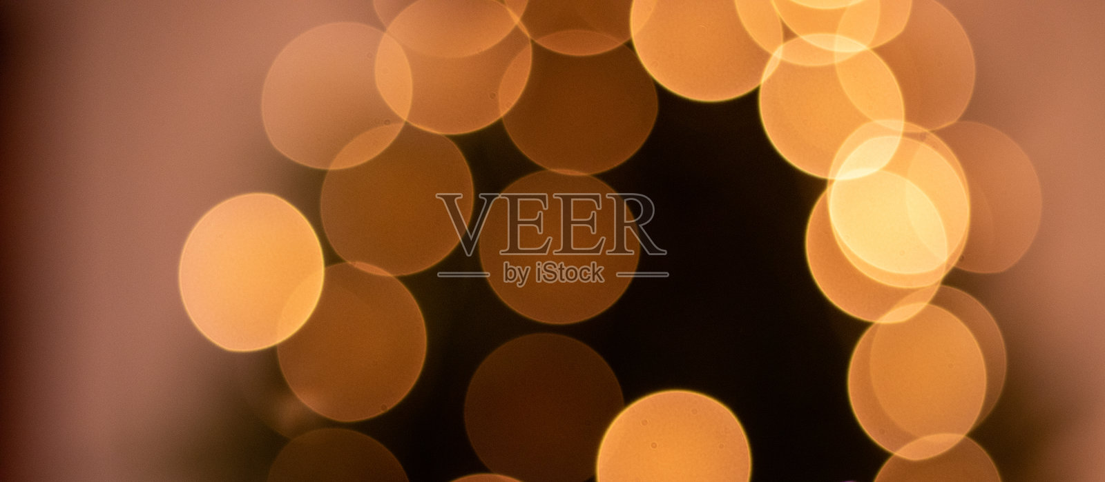 金色的散景,背景里的灯光,圣诞季节。照片摄影图片