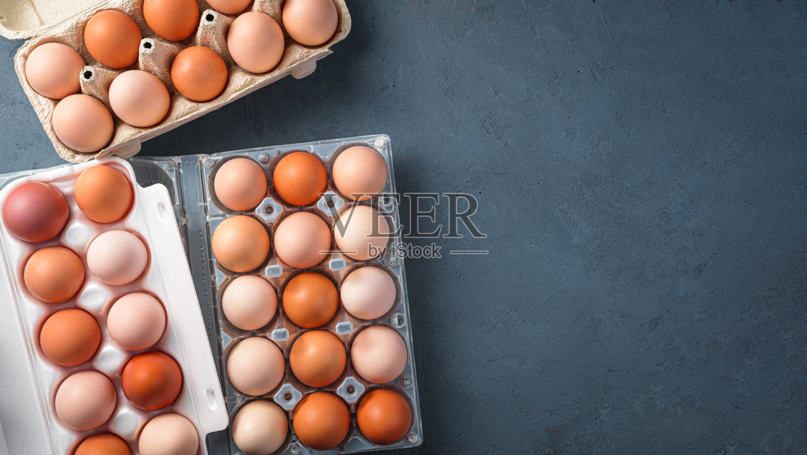 鸡蛋放在不同的包装上,背景是黑色的照片摄影图片