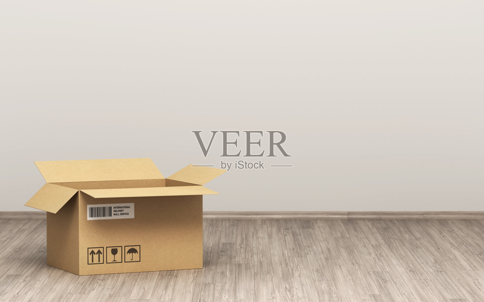 一个打开纸箱在木地板前的灰色墙壁股票照片照片摄影图片