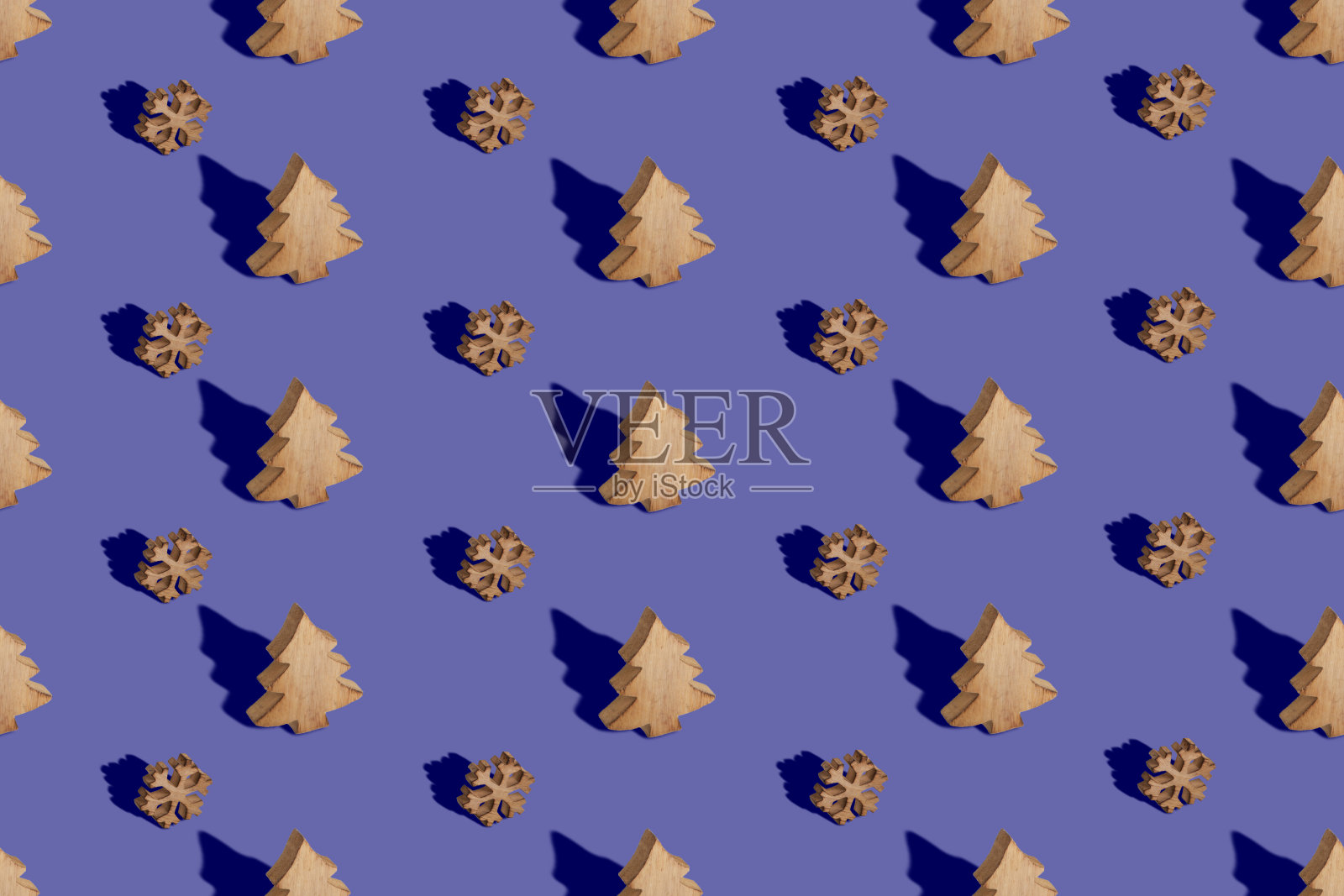 创意无缝图案由木制雪花和圣诞树玩具在2022年流行的颜色背景。照片摄影图片