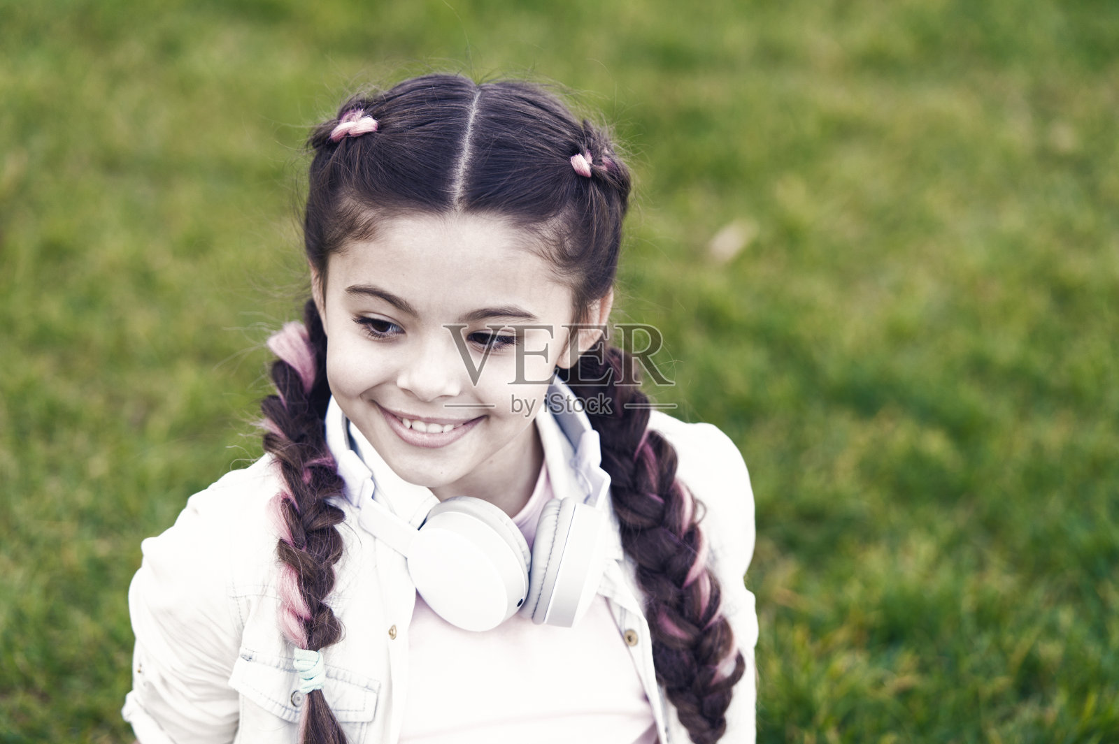 听音乐的小女孩,戴着耳机享受春日心情照片摄影图片