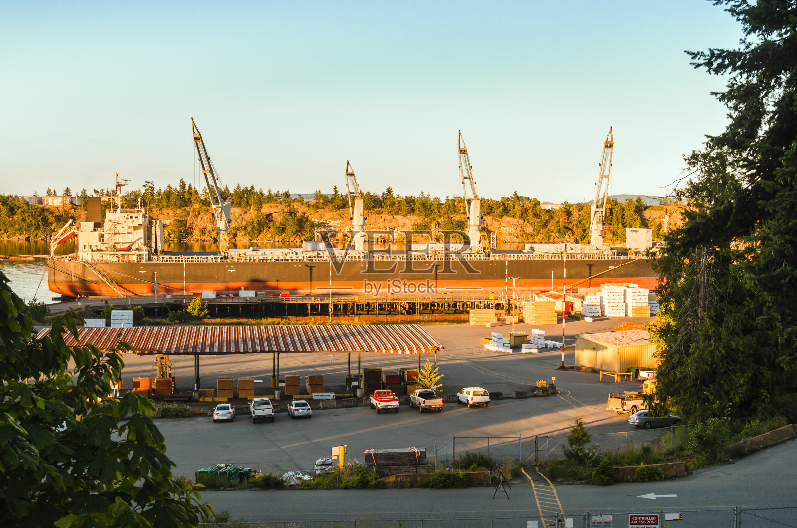 日落时停泊在港口的大型货轮照片摄影图片
