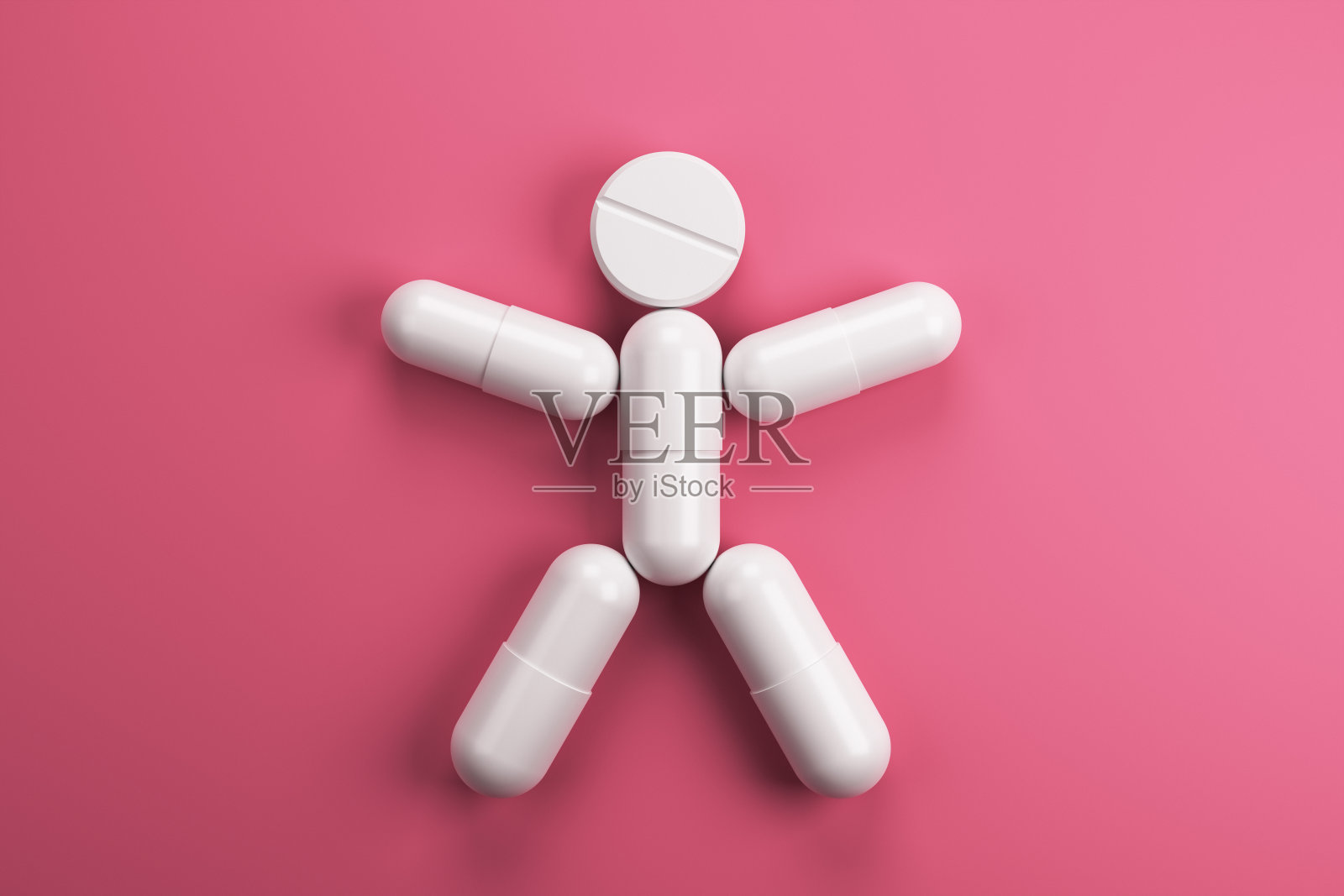 在粉红色的背景上画一个白色胶囊画。照片摄影图片