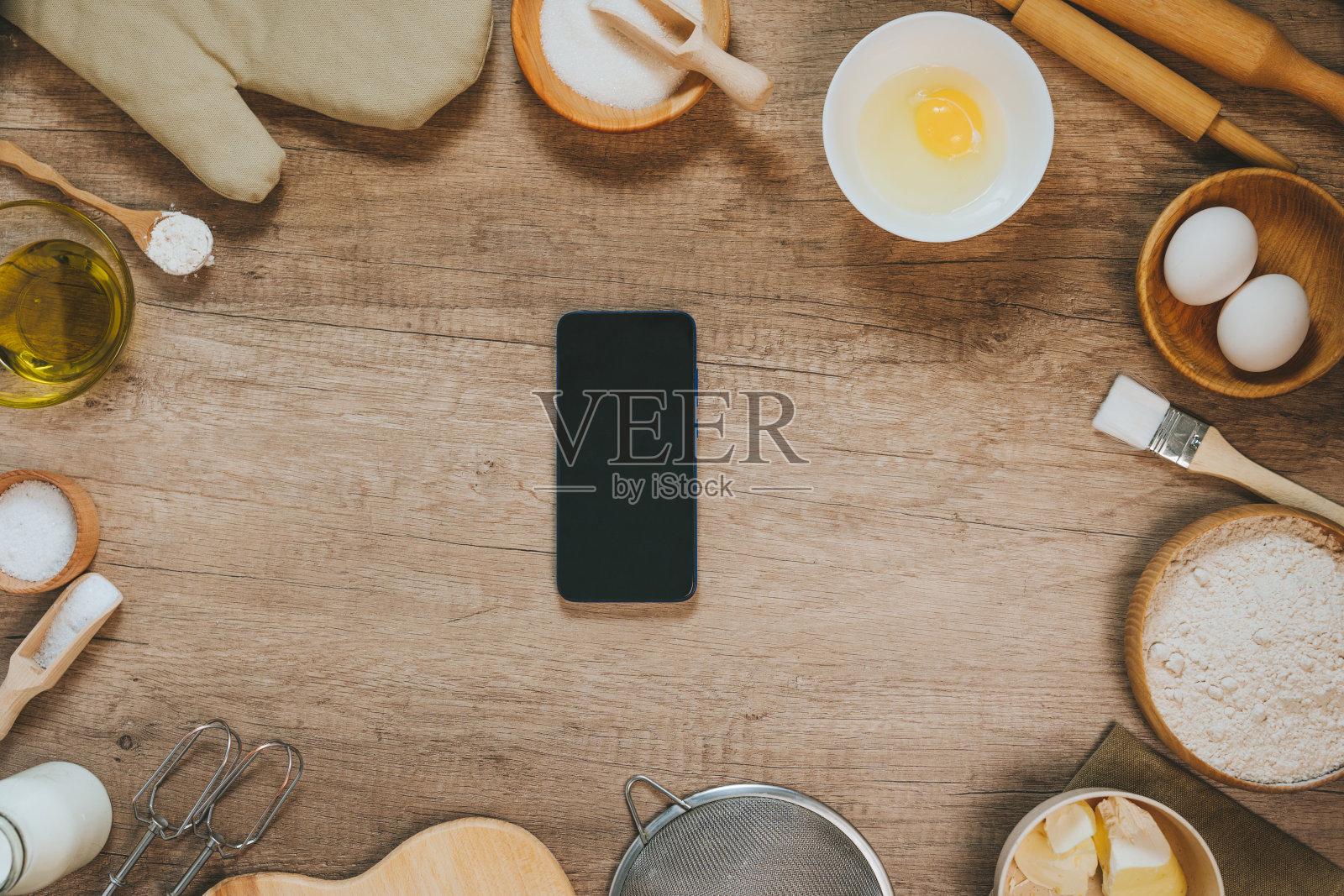准备面团的材料旁边没有屏幕的智能手机照片摄影图片