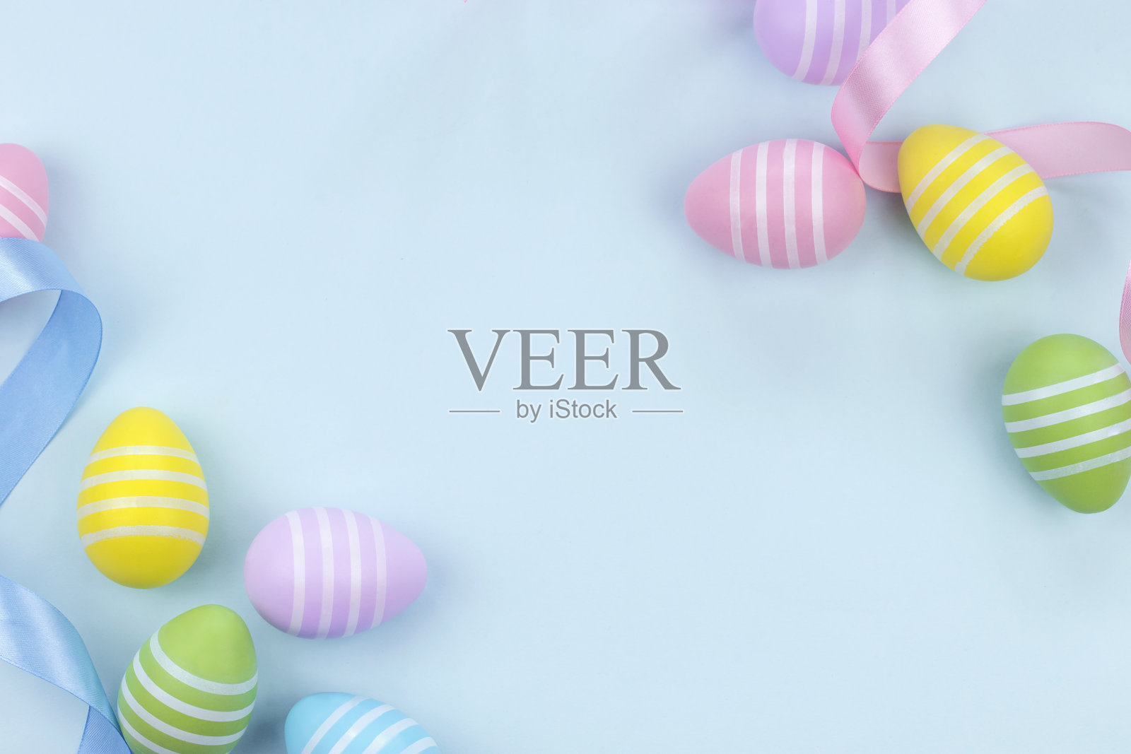 色彩柔和的复活节彩蛋配上蓝色和粉色的丝带照片摄影图片