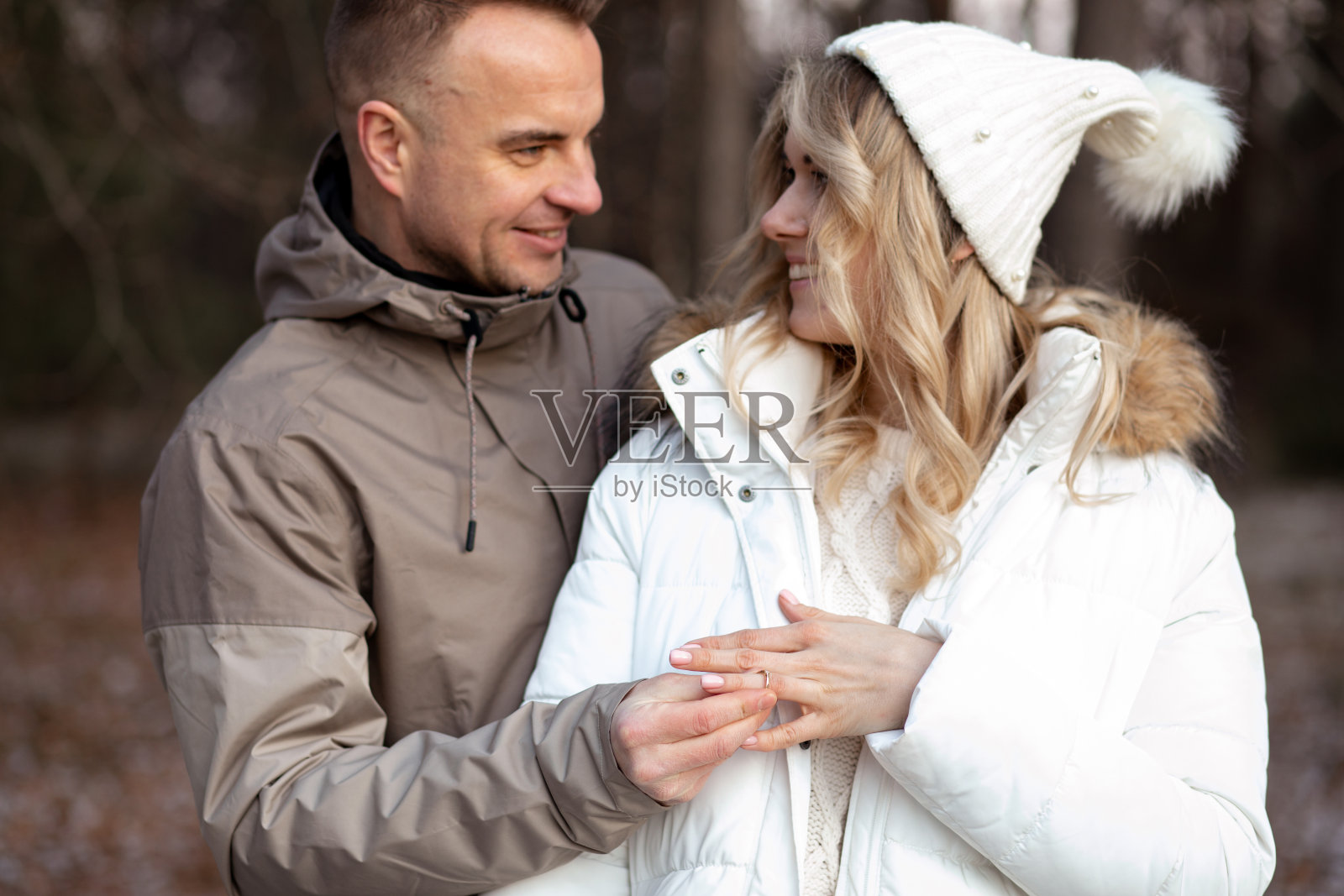 一对金发女人和男人的肖像,手交叉在户外的霜冻天气订婚在一起照片摄影图片