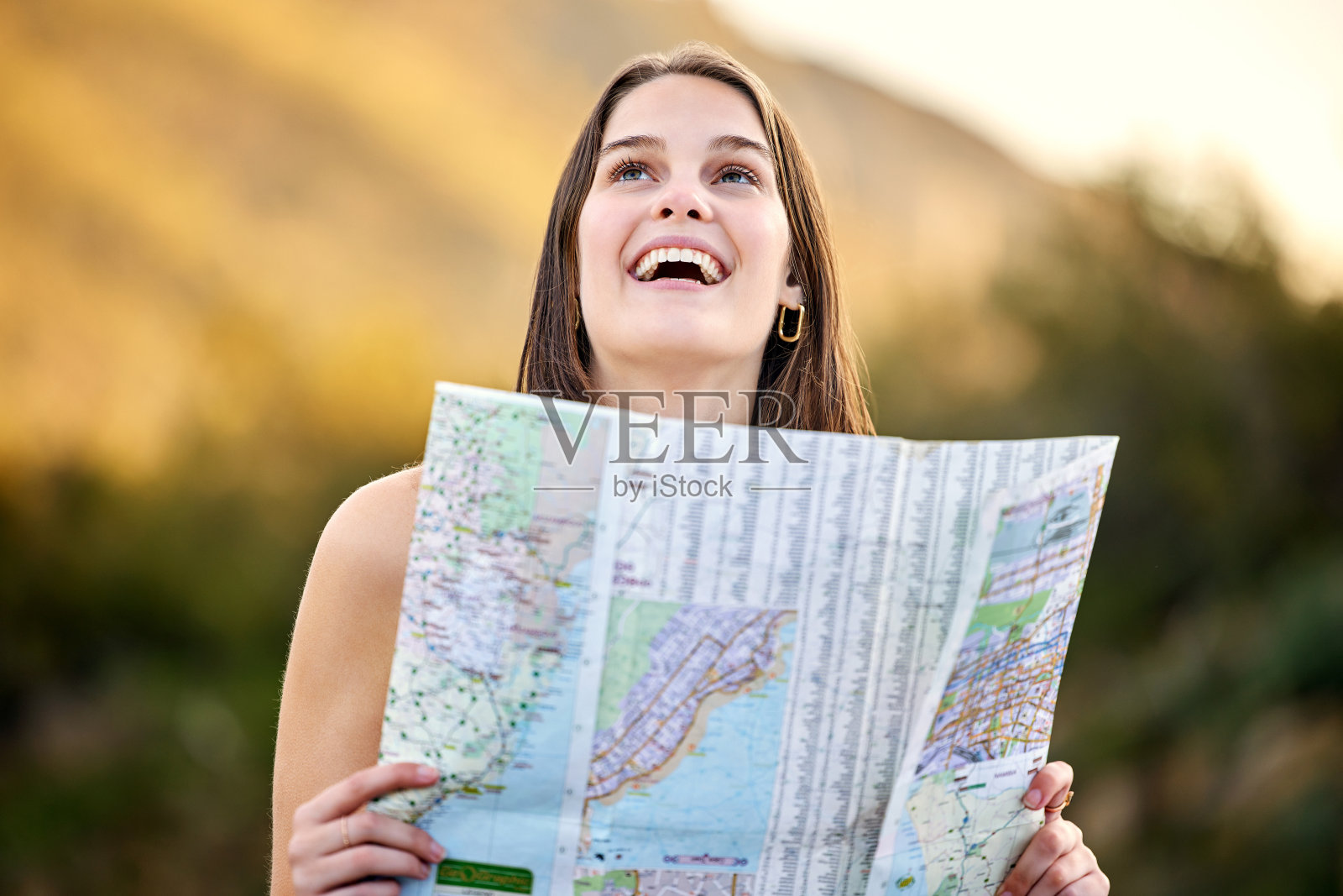 一名年轻女子手持地图外出探险照片摄影图片