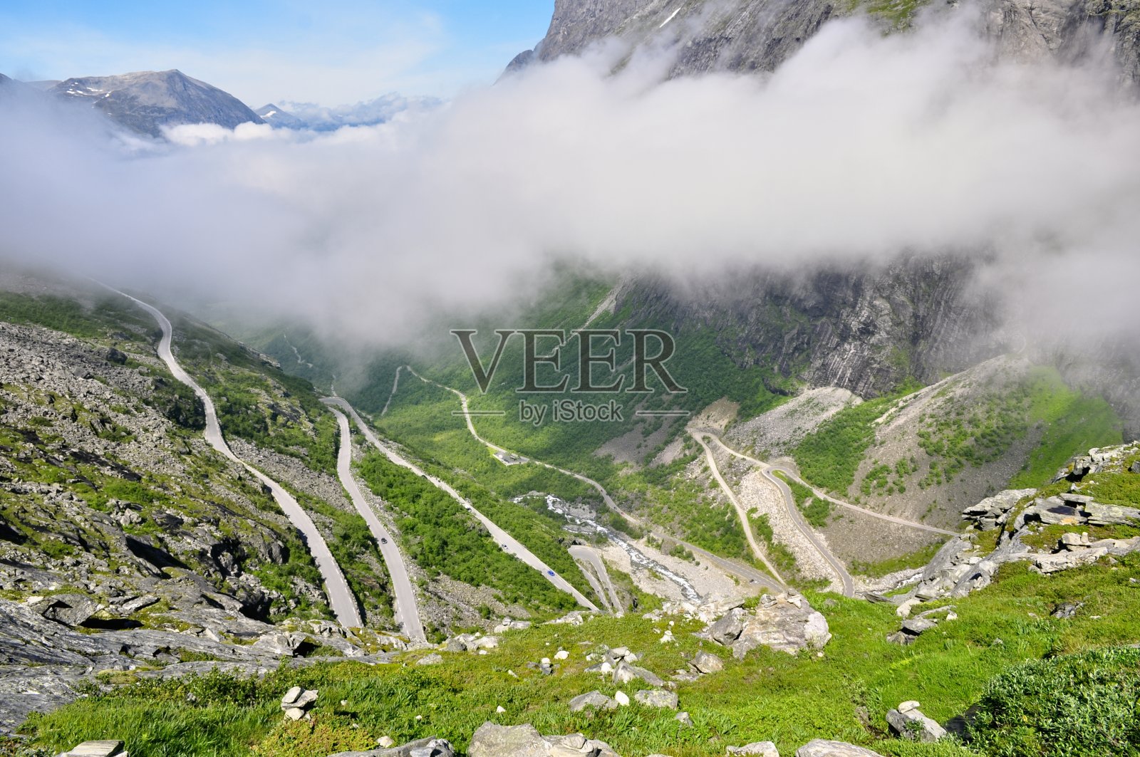 挪威的巨魔公路——狭窄的蜿蜒的道路穿过山脉和山谷。夏天的天气,云雾缭绕岩石。照片摄影图片