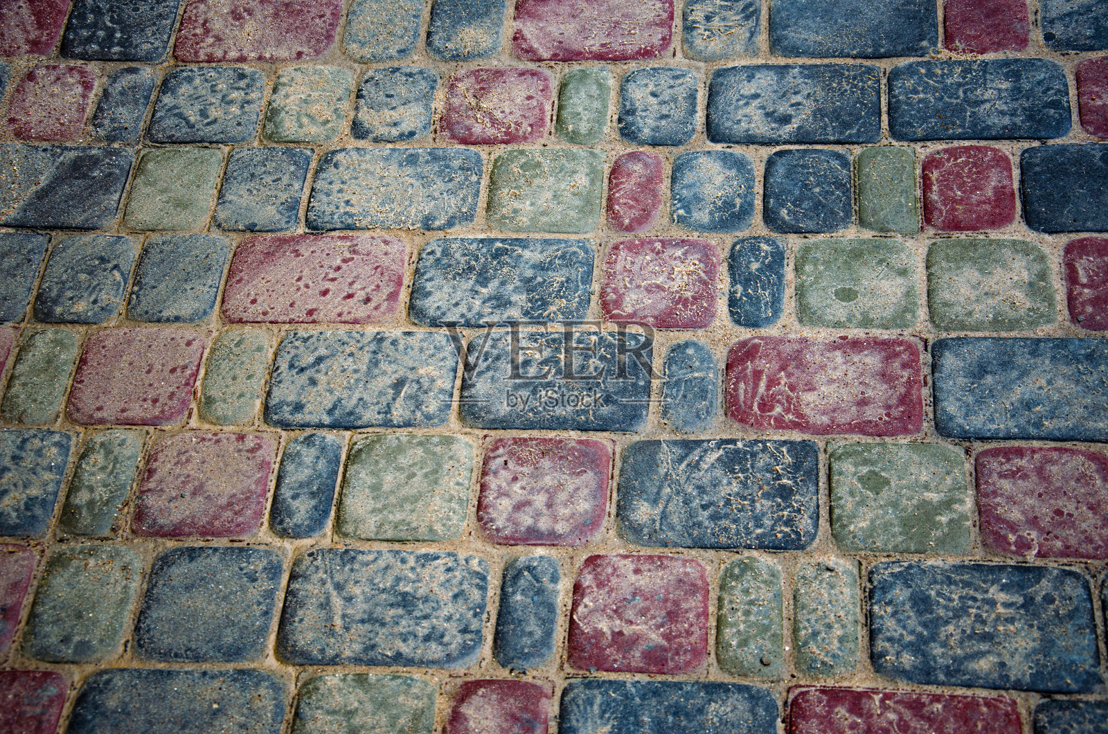 抽象的背景。旧的鹅卵石路面特写。城市照片摄影图片