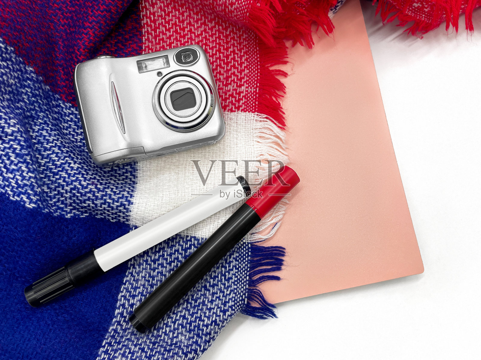 布局包括一台相机,毡尖笔,一本笔记本和一个格子。照片摄影图片