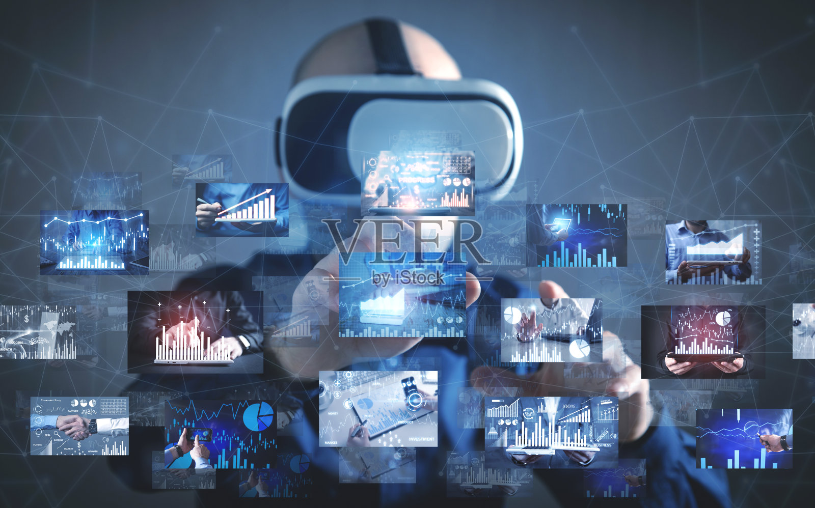 一个戴着虚拟现实眼镜的男人正在触摸一张商业图表的数码照片。照片摄影图片