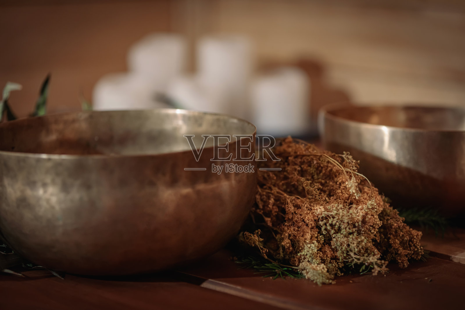 木质背景上的颂钵、干草束与蜡烛照片摄影图片