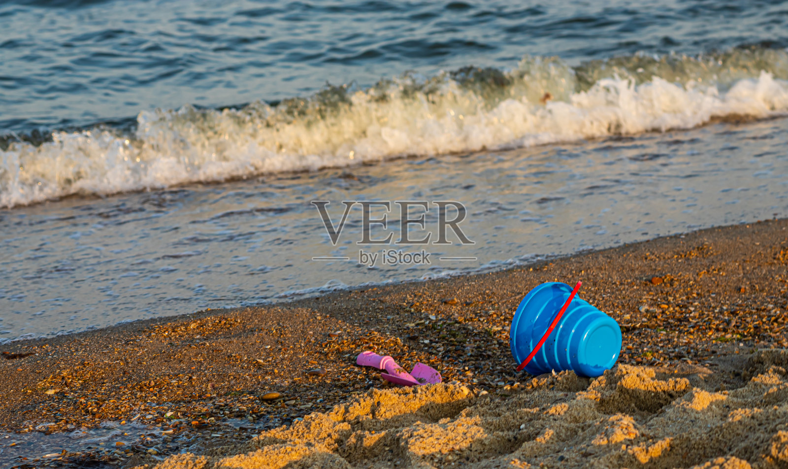 沙滩上的儿童玩具,背景是蓝天和大海照片摄影图片