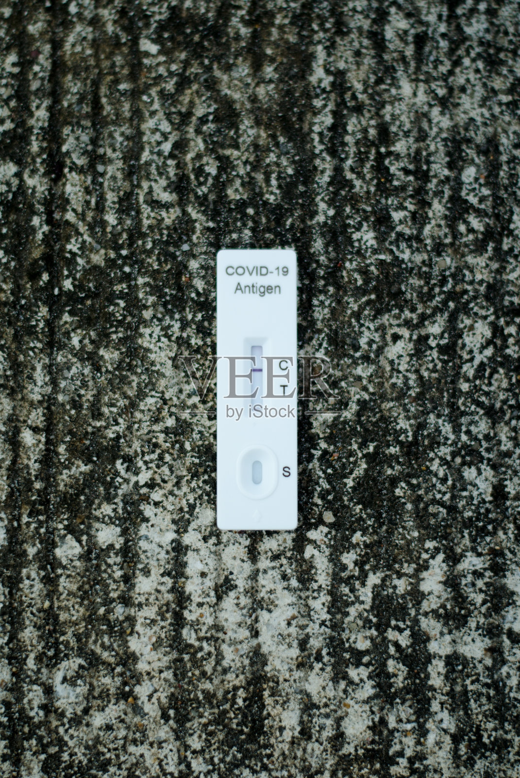 手持抗原检测试剂盒条或ATK阴性结果,covid-19自我快速检测理念。照片摄影图片