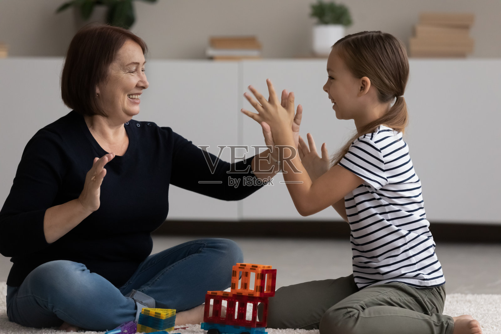 快乐成熟的奶奶和小孙女一起玩有趣的游戏照片摄影图片