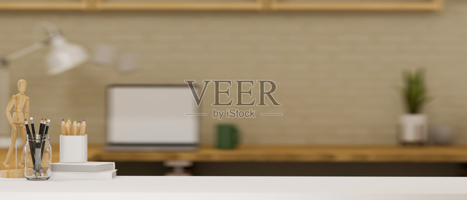 一个现代的白色办公桌与复印空间在模糊的办公室背景。照片摄影图片