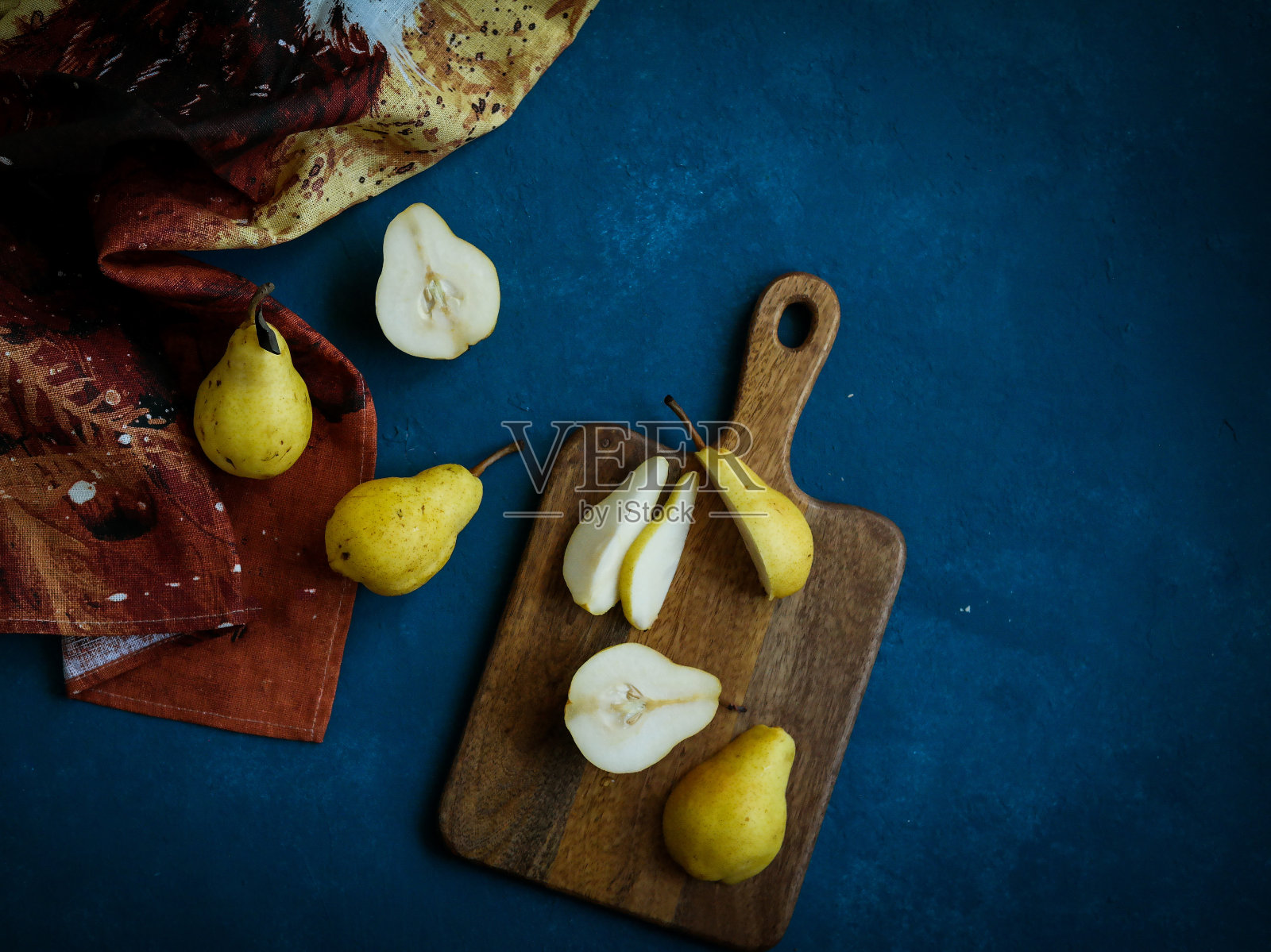 蓝色背景上的黄色梨照片摄影图片