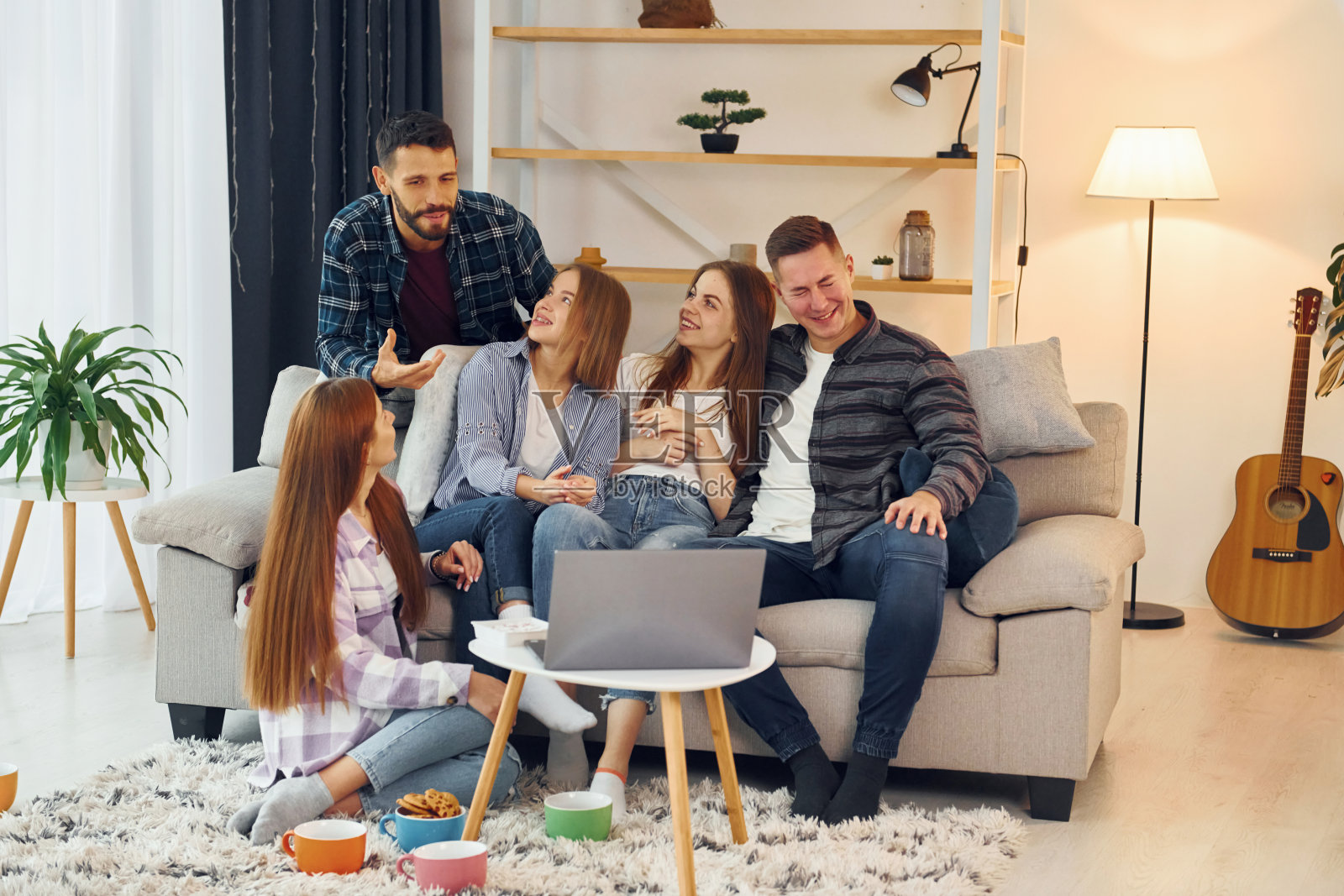 使用笔记本电脑。一群朋友一起在室内聚会照片摄影图片